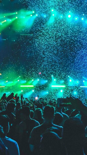 An energetic concert crowd is enjoying the vibrant blue lighting and confetti effects, HD Phone Wallpaper