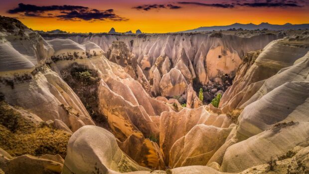 The eroded rock formations create a unique landscape in Cappadocia during sunset, 4K Desktop Wallpaper