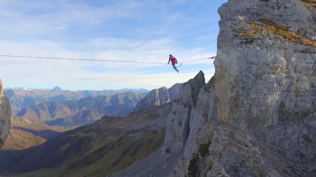 Extreme highline slacklining between mountain cliffs with panoramic alpine view wallpapers