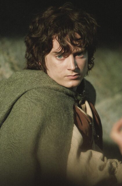 Frodo Baggins In Adventure Pose Wallpaper For Fans