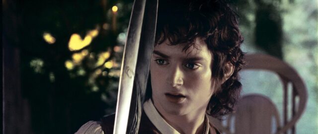 Frodo Wallpaper Magic Moment With Sword In Forest Scene