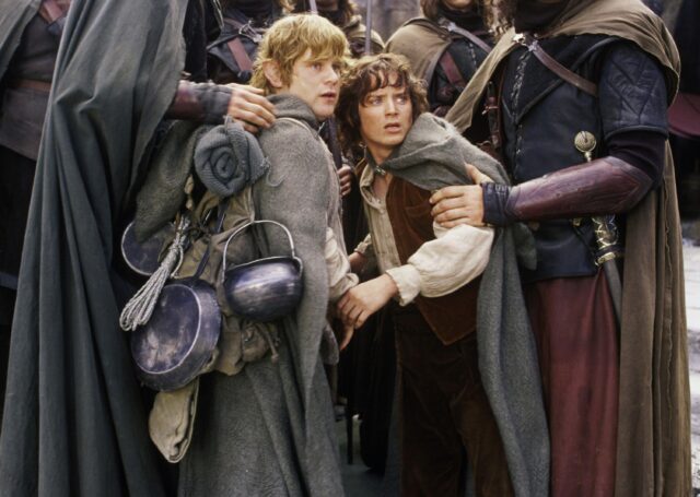Frodo And Companions In Middle Earth Adventure Scene Wallpaper