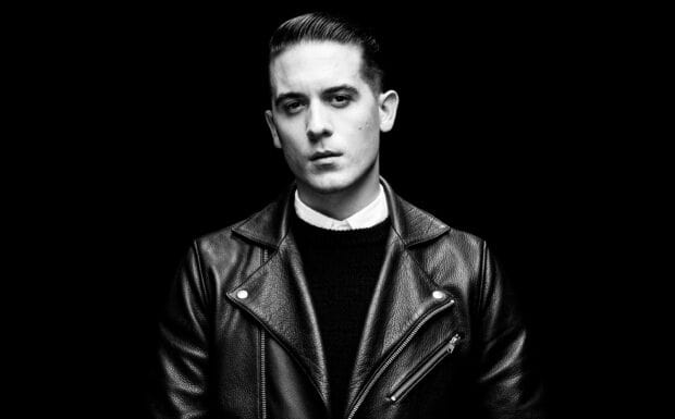 A serious man wearing a leather jacket is captured in this G Eazy Wallpapers image, 2K Desktop Wallpaper