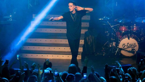 G Eazy performs energetically while holding a microphone during a concert, HD Desktop Wallpaper