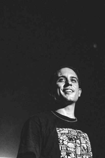G Eazy smiles confidently with a graphic shirt in a black and white setting, HD Mobile Wallpaper