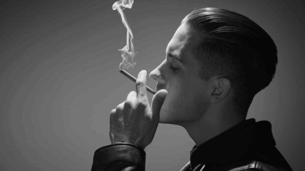 G Eazy is smoking a cigarette in a black and white portrait, HD Desktop Wallpaper