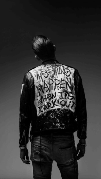 A man wearing a painted leather jacket with the phrase These Things Happen When Its Dark Out stands facing backward, 4K Phone Wallpaper