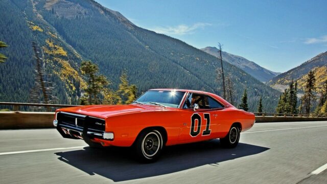 General Lee Charger Car Driving Through Mountain Road Scenic Wallpaper