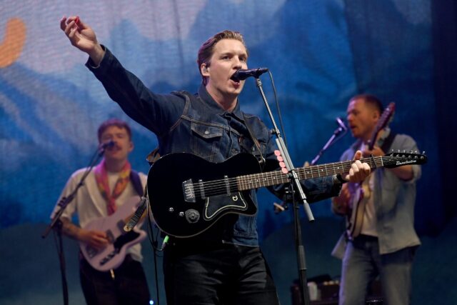 George Ezra Performing Live on Stage with Guitar Background Band Wallpaper