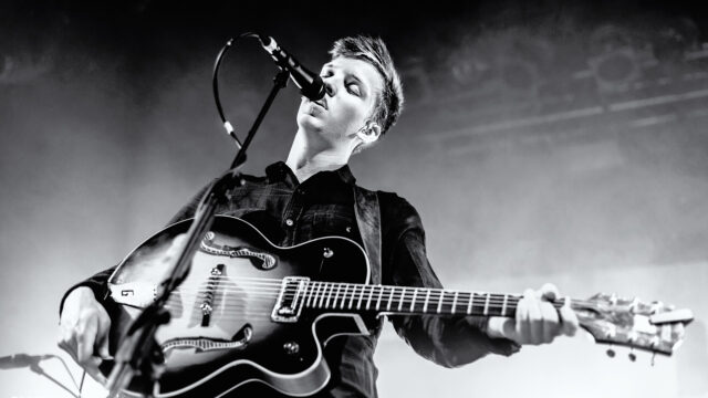 George Ezra live performance playing guitar black and white wallpaper