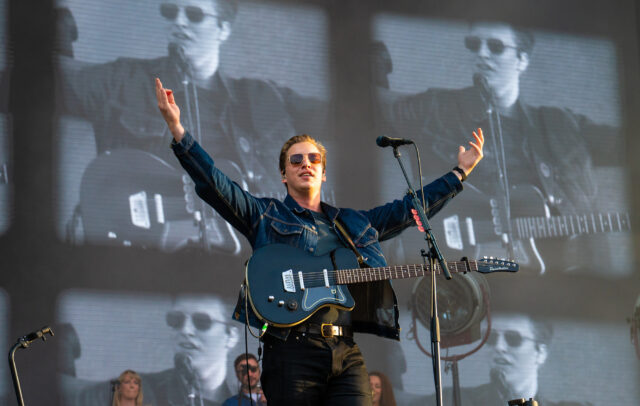 George Ezra live performance with guitar on stage concert wallpaper background
