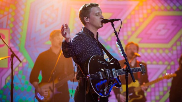 George Ezra live performance with guitar vibrant colorful background George Ezra wallpapers