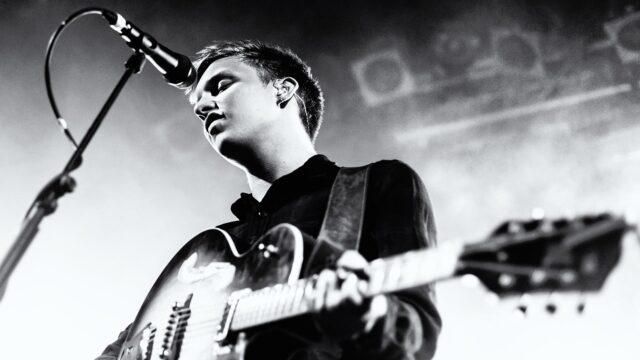George Ezra performing live with guitar black and white wallpaper