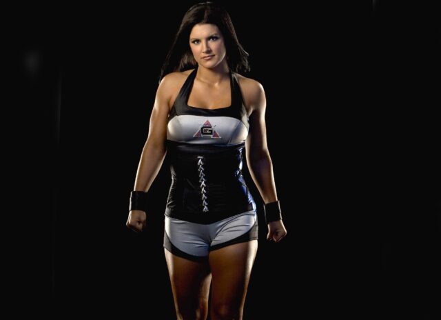 Gina Carano Powerful Stance in Black and White MMA Outfit Wallpaper