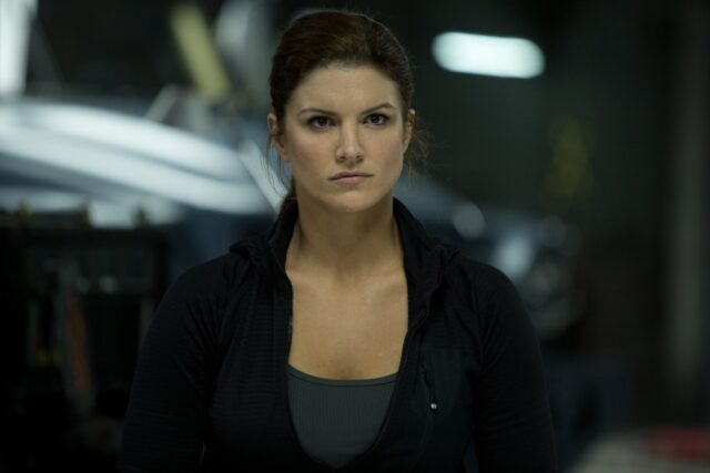 Gina Carano intense look in action scene cinematic wallpaper