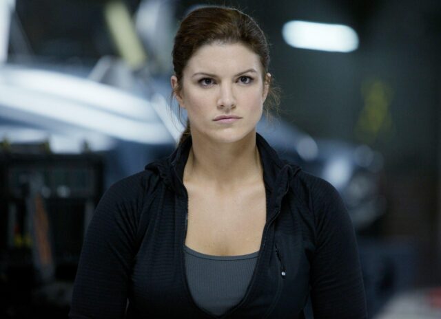 Gina Carano intense look in black jacket action movie scene wallpaper