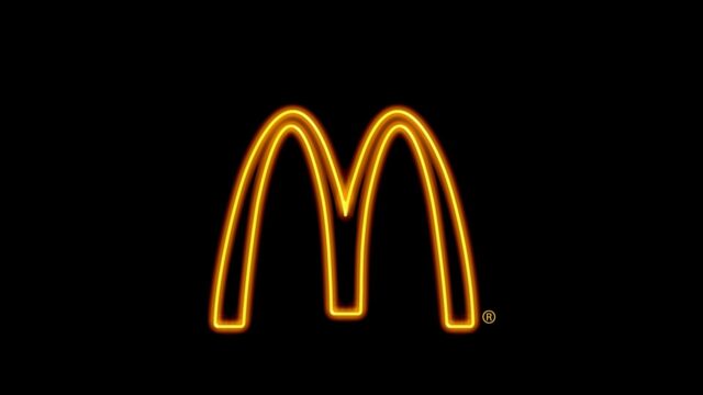 Glowing McDonalds Logo on Black Background Minimalist Wallpaper