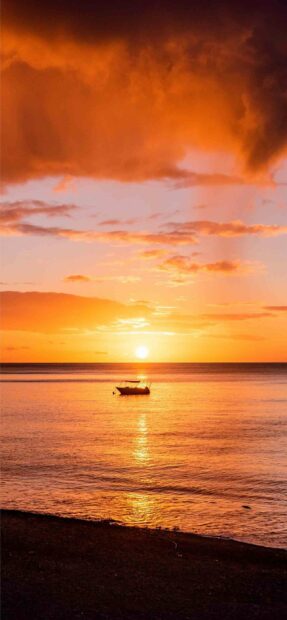 A golden sunset with calm water and a boat floating near the shore in Dominica wallpapers, 2K Phone Wallpaper
