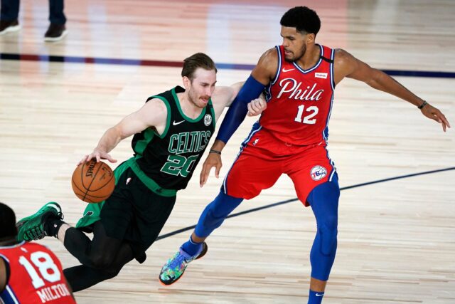 Gordon Hayward Driving to Basket Against Philadelphia 76ers Defensive Wall Basketball Wallpaper