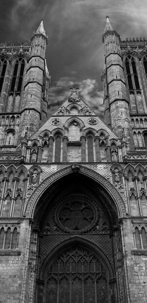 The cathedral features detailed Gothic architecture with pointed arches and ornate stone carvings, 2K Phone Wallpaper