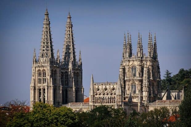 The cathedral displays intricate Gothic architecture with tall spires and detailed stonework, 2K Desktop Wallpaper