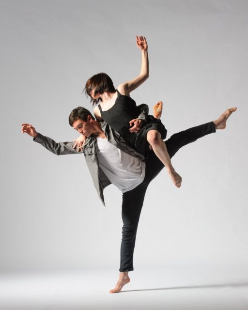 Graceful Contemporary Dance Duo Performance in Studio Background Wallpaper