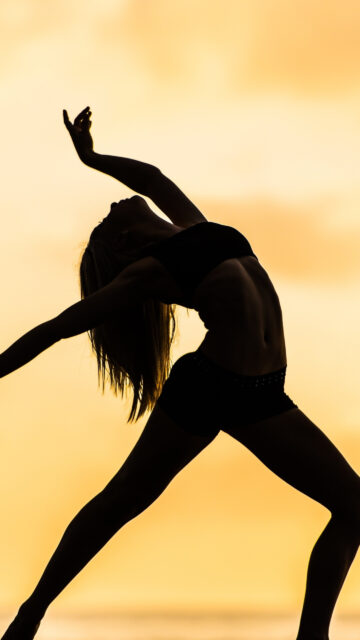 Graceful Contemporary Dance Silhouette Wallpaper with Warm Sunset Background