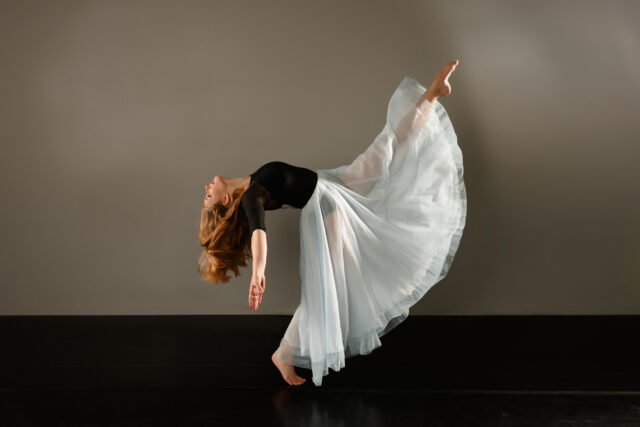Graceful Contemporary Dance Wallpaper Featuring Female Dancer in Flowing Skirt