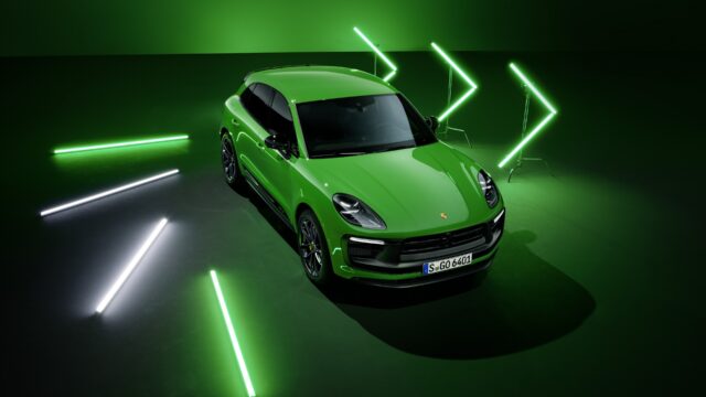 Green Porsche Macan GT Sporty SUV Surrounded by Neon Lights Wallpaper