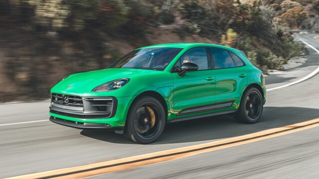 Green Porsche Macan GTS driving on winding mountain road high quality wallpaper