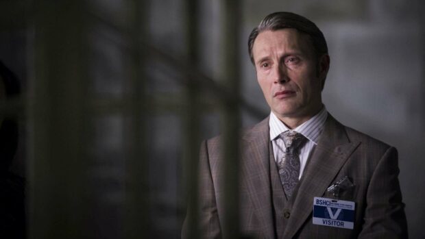 Hannibal Mads Mikkelsen wears a visitor badge and looks serious in a suit, HD Desktop Wallpaper