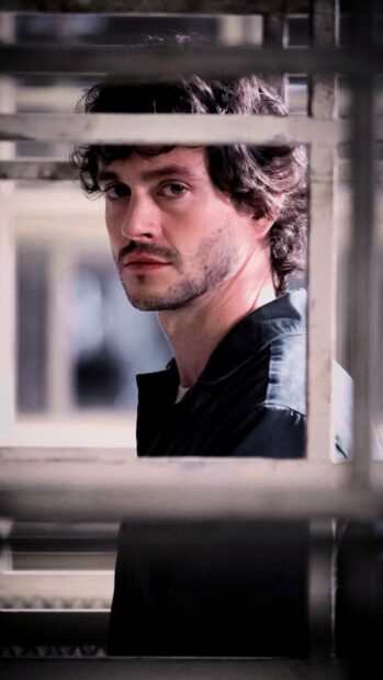 A man looks intensely through window bars in a dramatic scene of Hannibal Mads Mikkelsen, HD Phone Wallpaper