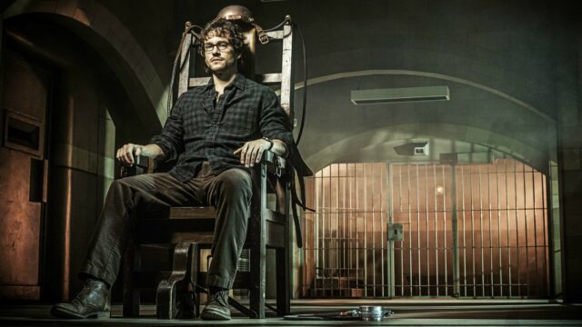 Hannibal TV Series Wallpaper Featuring Character in Dimly Lit Prison Chair Scene