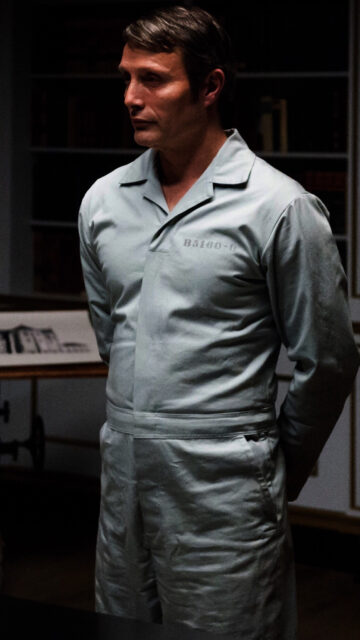 Hannibal TV Series Wallpaper Featuring Prisoner Character in Dimly Lit Room