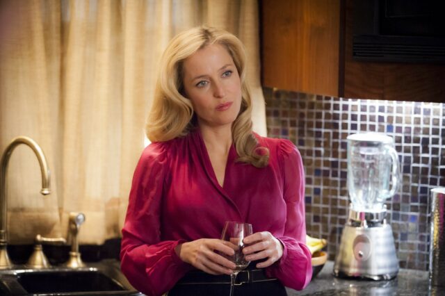 Hannibal TV Series Wallpaper Featuring Woman in Red Blouse Holding a Glass in Kitchen