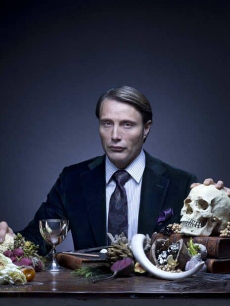 Hannibal Mads Mikkelsen poses with a skull and food on the table, HD Mobile Wallpaper