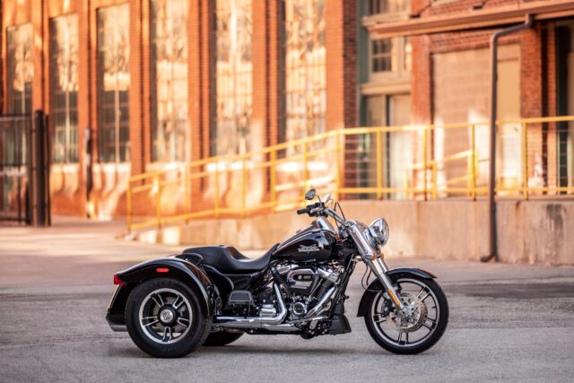 Harley Davidson Freewheeler Trike Parked In Urban Setting Wallpaper