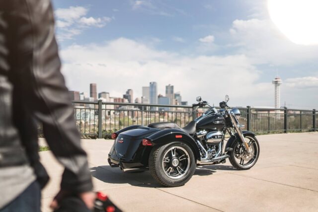 Harley Davidson Freewheeler Trike With Cityscape Background