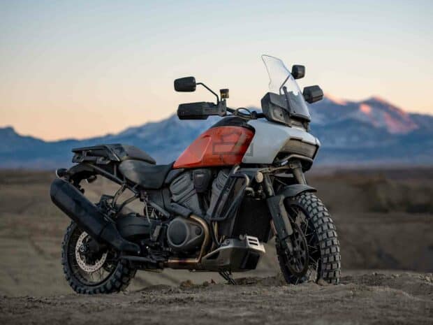 A Harley Davidson Pan America 1250 motorcycle is parked off road with mountains in the background, HD Desktop Wallpaper