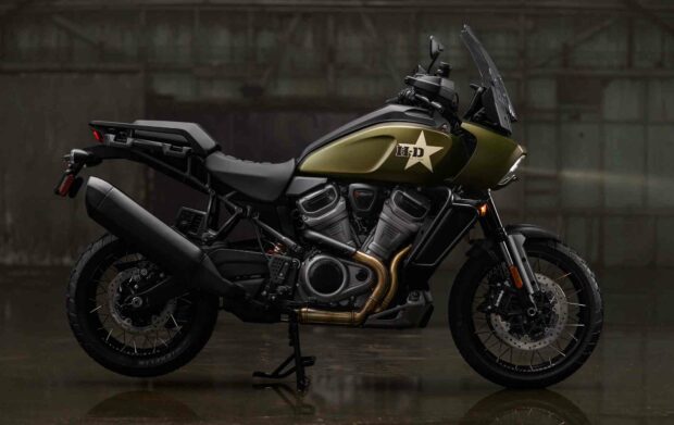 The Harley Davidson Pan America 1250 adventure motorcycle stands still in a dark garage