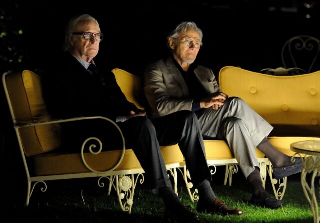 Harvey Keitel Relaxing On Yellow Couch For Wallpaper Background