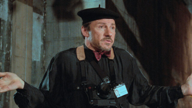 Harvey Keitel In Artistic Beret And Camera Scene Wallpaper