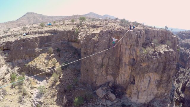 Highline Slacklining Over Rocky Canyon Landscape Wallpaper