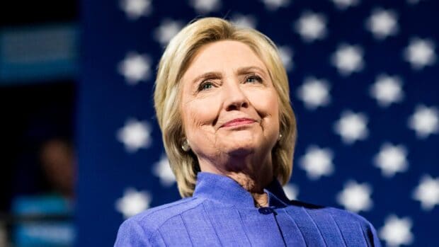Hillary Clinton stands confidently in front of a star spangled background, HD Desktop Wallpaper