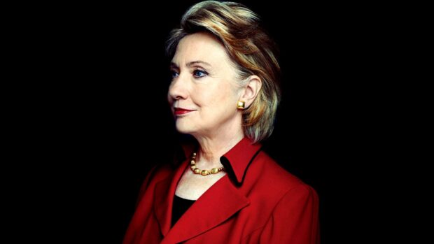 Hillary Clinton wears a red jacket and gold necklace in a side profile, HD Desktop Wallpaper