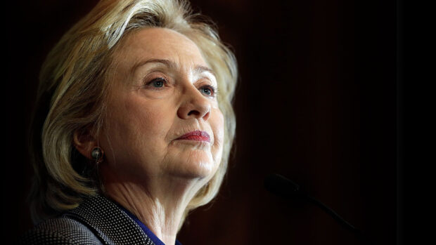 Hillary Clinton looks thoughtful during a speech with a dark background, HD Desktop Wallpaper
