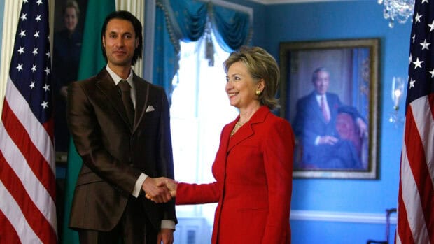 Hillary Clinton Wallpapers show a friendly greeting between two people in a formal room, HD Desktop Wallpaper