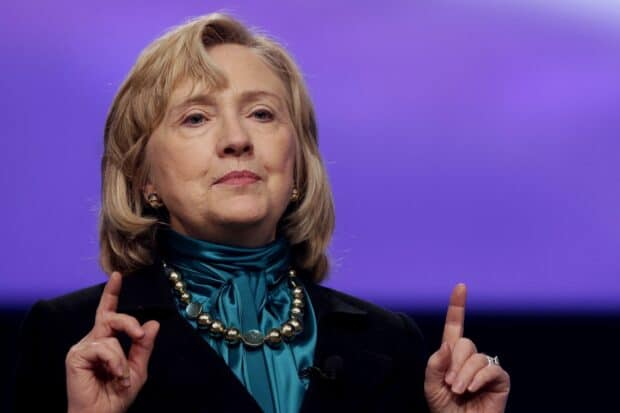 Hillary Clinton is speaking with a serious expression and gesturing with her hands, 2K Desktop Wallpaper