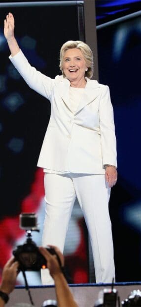 Hillary Clinton waving on stage during a public event, HD Mobile Wallpaper