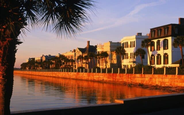 Historic South Carolina Waterfront Sunset with Palm Trees and Classic Homes Wallpaper